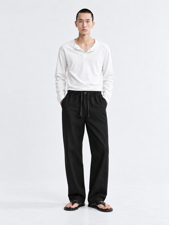 DILI men's black relaxed straight-fit drawstring trousers styled with a white Henley T-shirt.