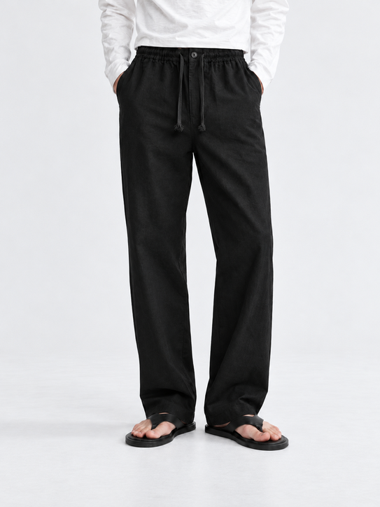 DILI men's black relaxed straight-fit drawstring trousers styled with a white Henley T-shirt.