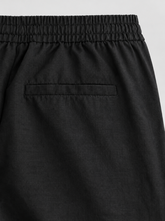 DILI men's black relaxed straight-fit drawstring trousers styled with a white Henley T-shirt.
