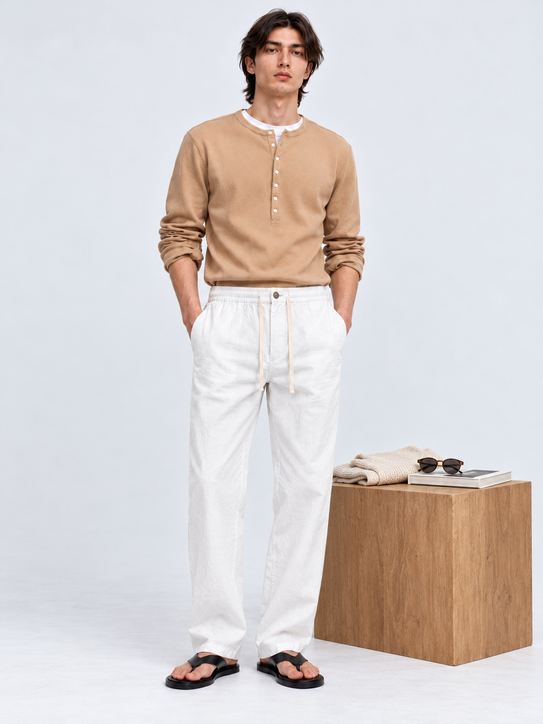 DILI men's white relaxed straight-fit trousers with adjustable drawstrings, styled with a beige Henley T-shirt.