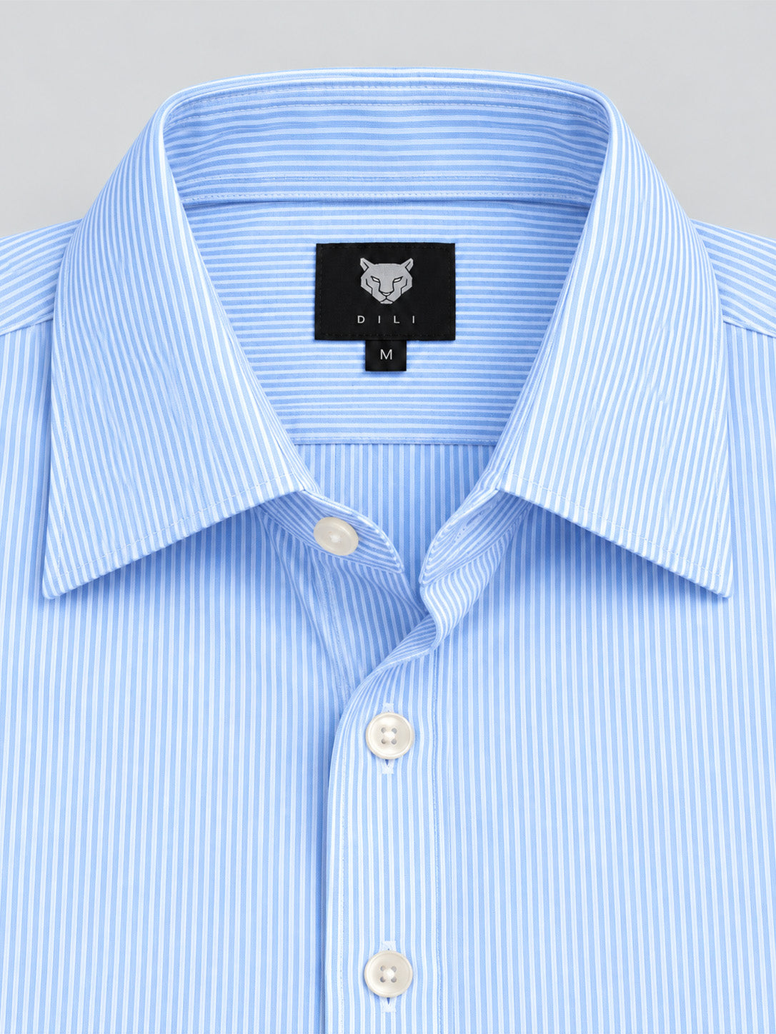 DILI tiger brand label and fine light blue striped fabric close-up