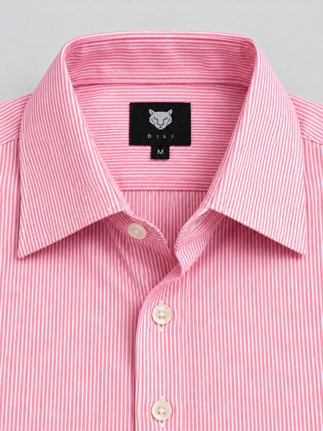 DILI tiger brand label and fine pink striped fabric close-up
