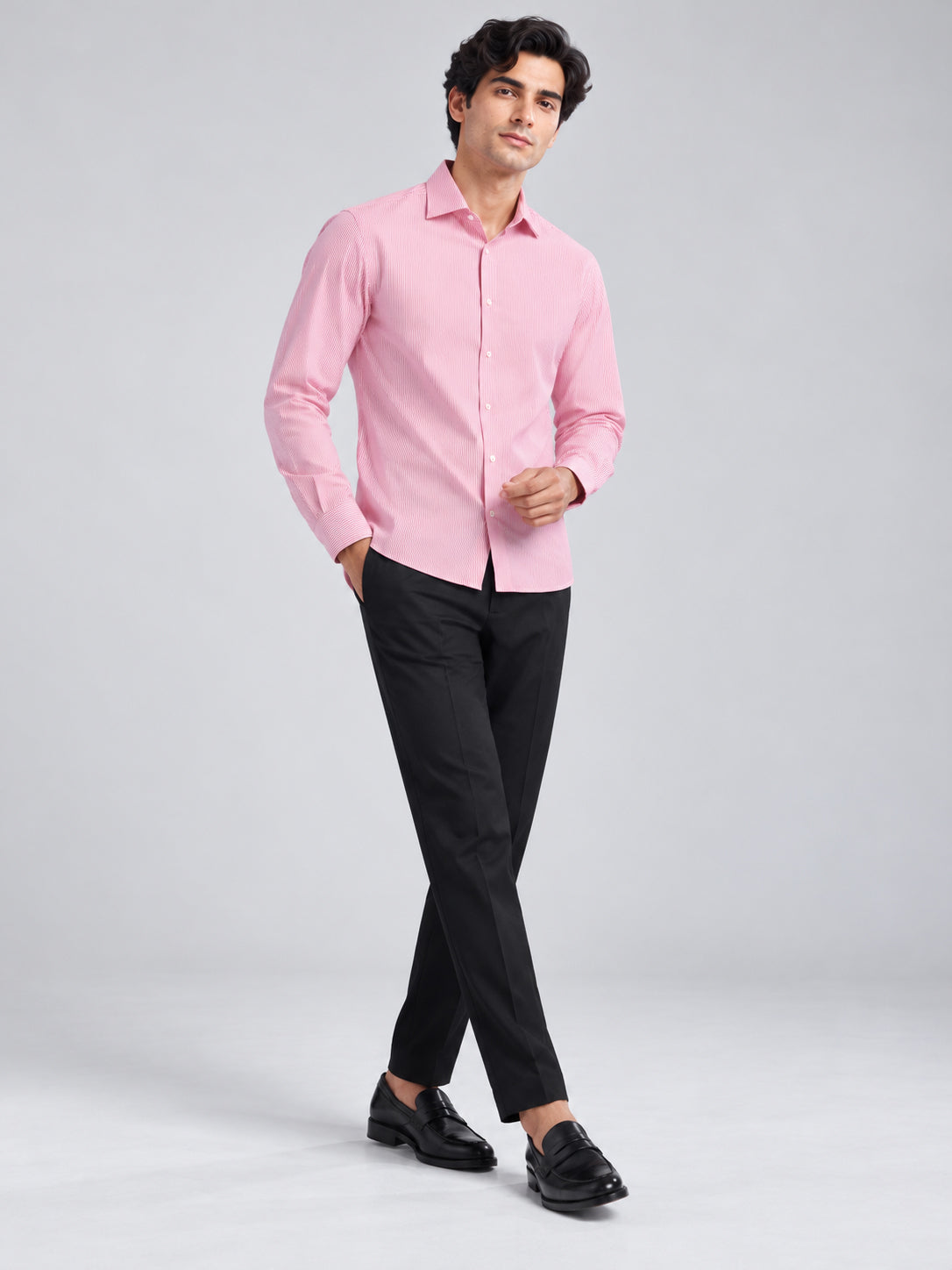 Model wearing pink striped DILI shirt with black trousers