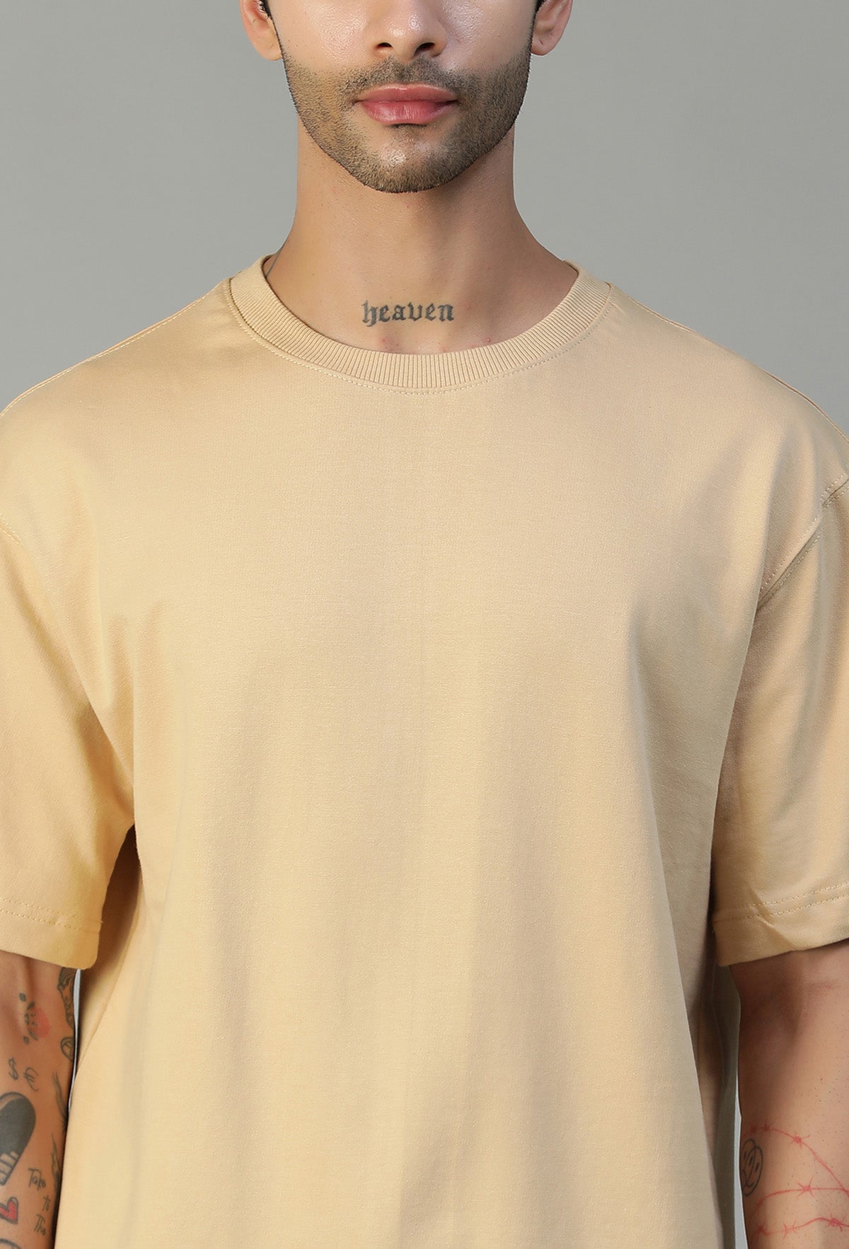 Close-up of beige cotton oversized T-shirt crew neck and fabric
