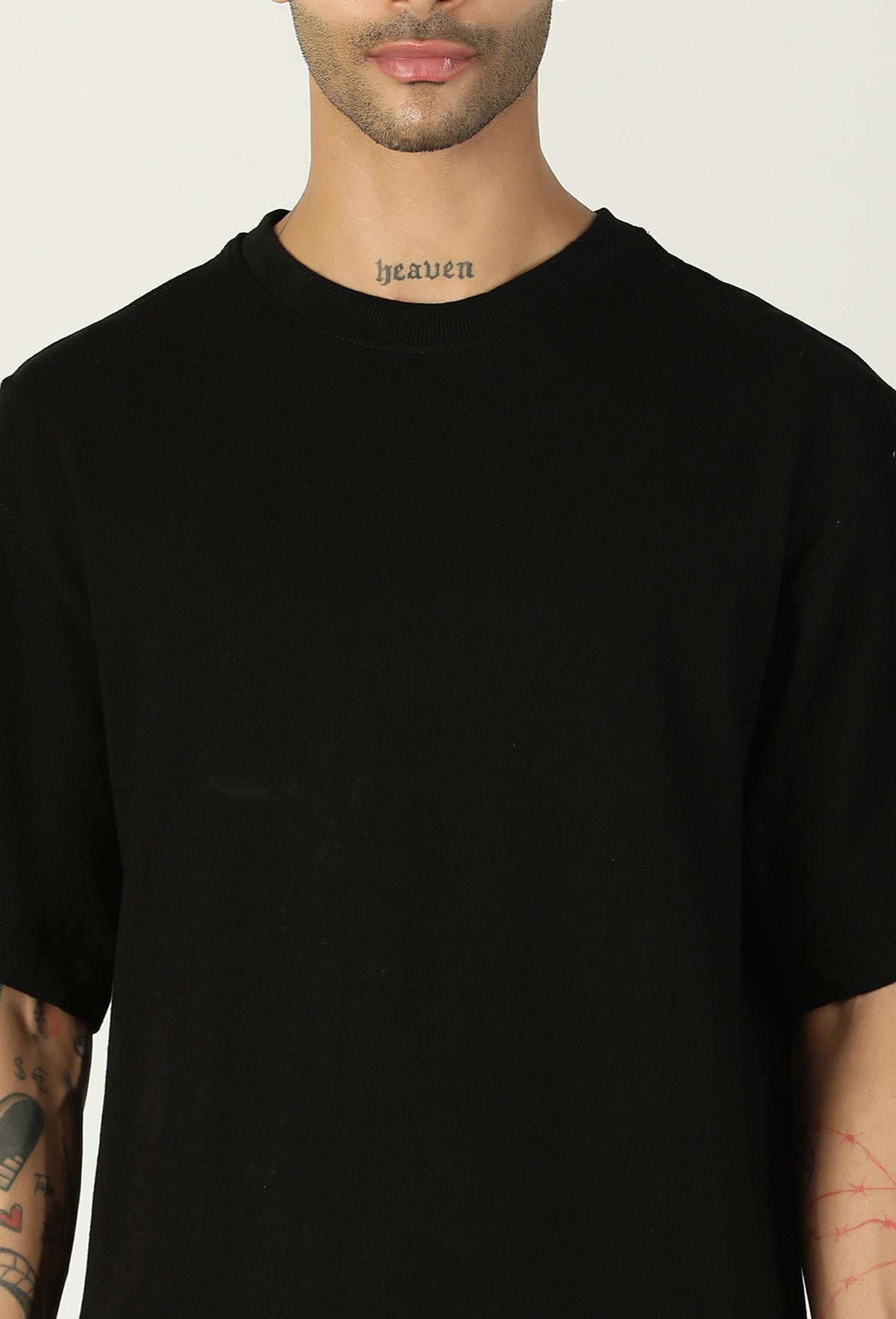 Close-up of black cotton oversized T-shirt crew neck and fabric