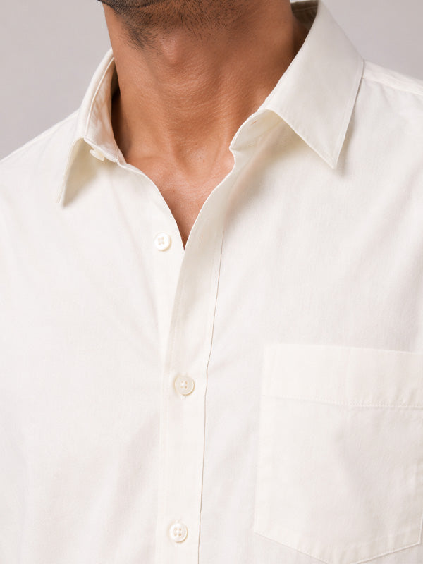 Close-up of cream cotton shirt collar, buttons and fabric