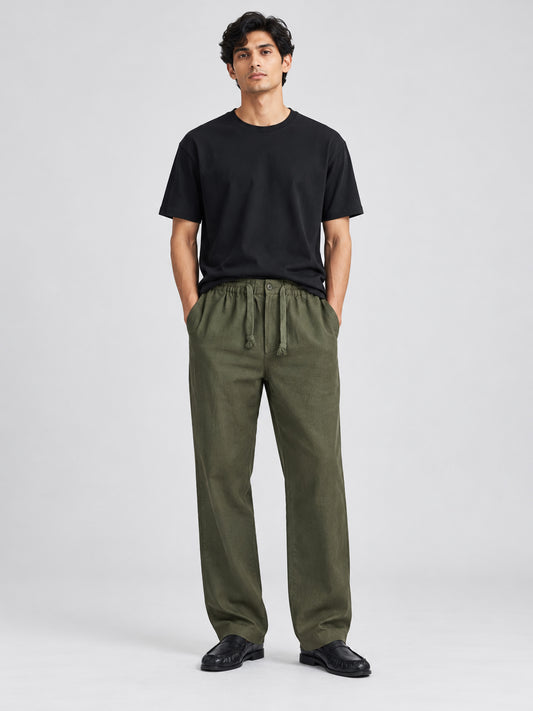 Model wearing DILI men's dark olive green linen-cotton straight-fit trousers