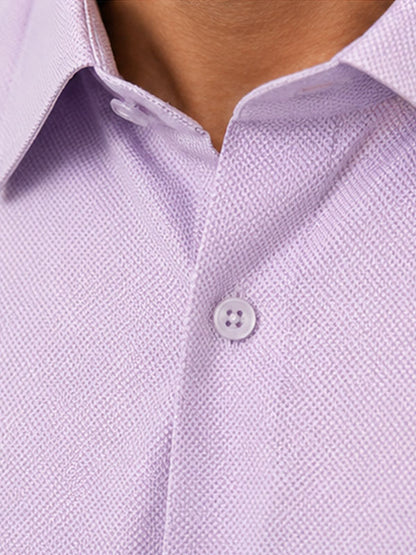 Close-up of lavender textured cotton shirt collar, buttons and fabric