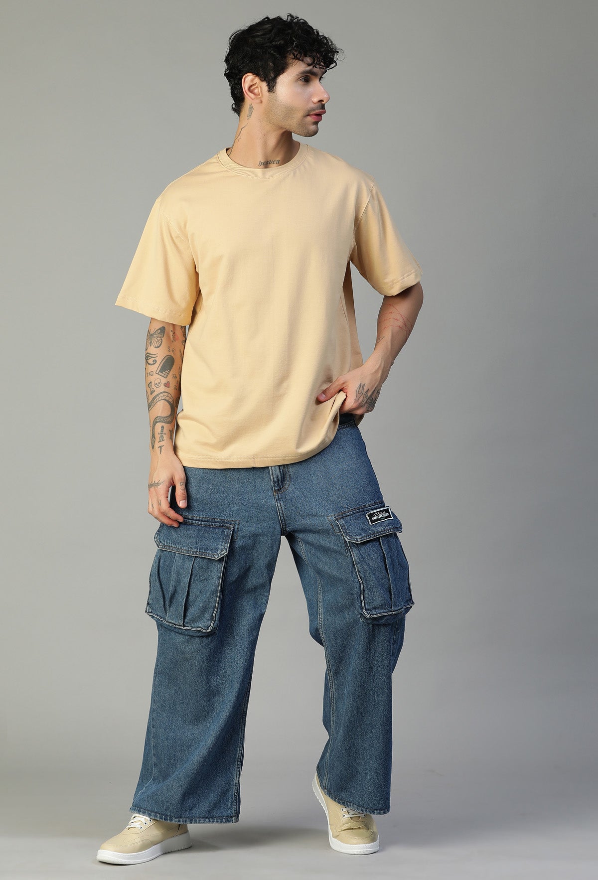 Full-length view of men's solid beige oversized cotton T-shirt