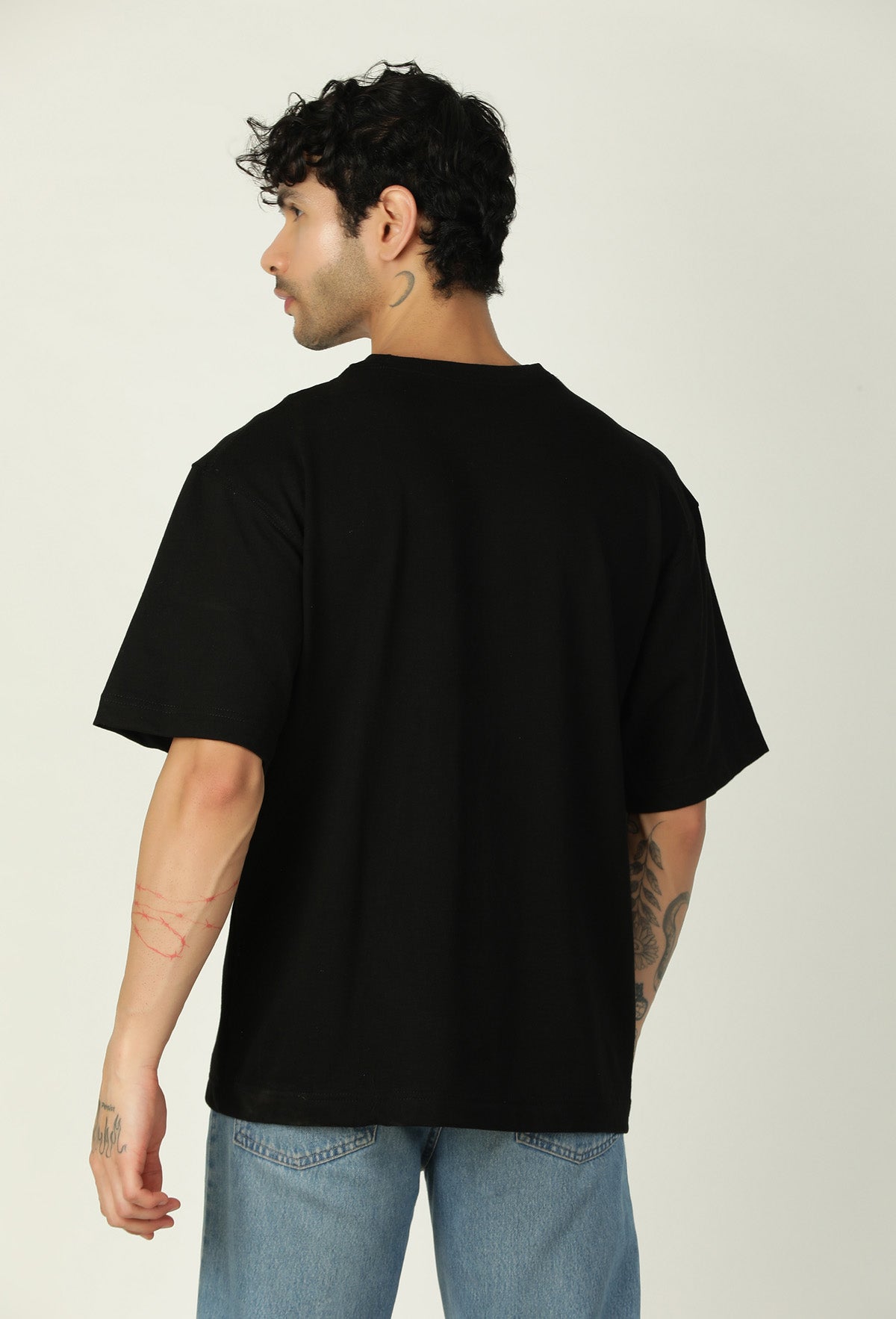 Back view of men's solid black pure cotton oversized T-shirt