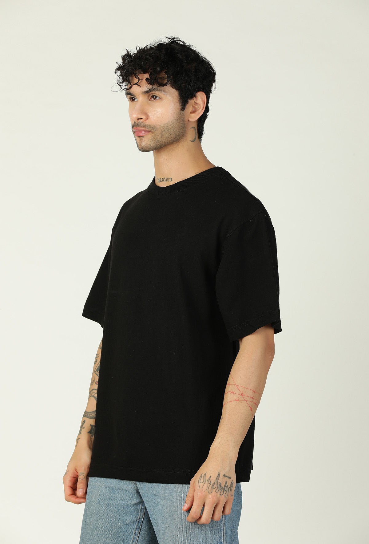 Side view of men's solid black oversized cotton T-shirt