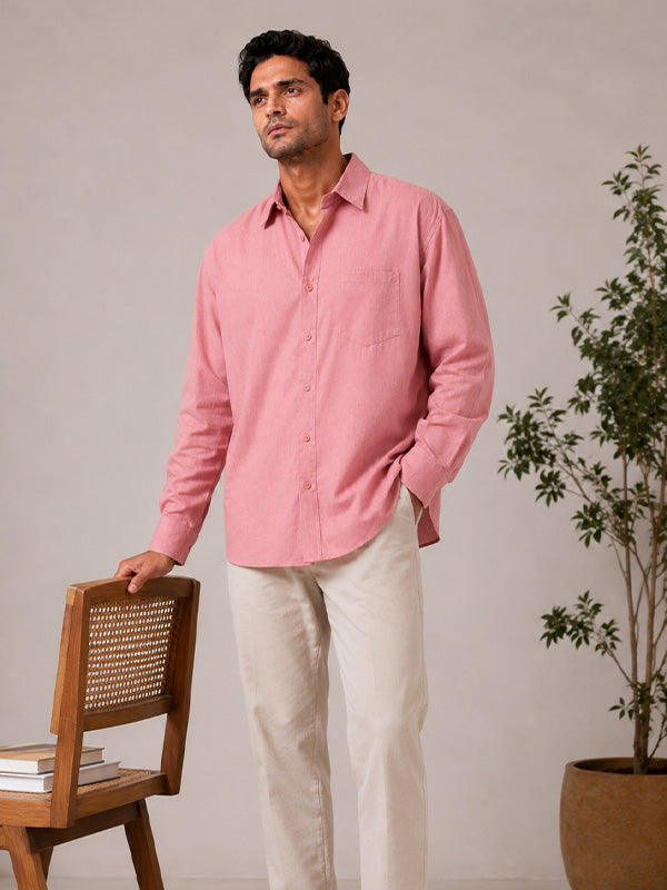 Man wearing a blush pink linen-cotton shirt in a casual lifestyle setting