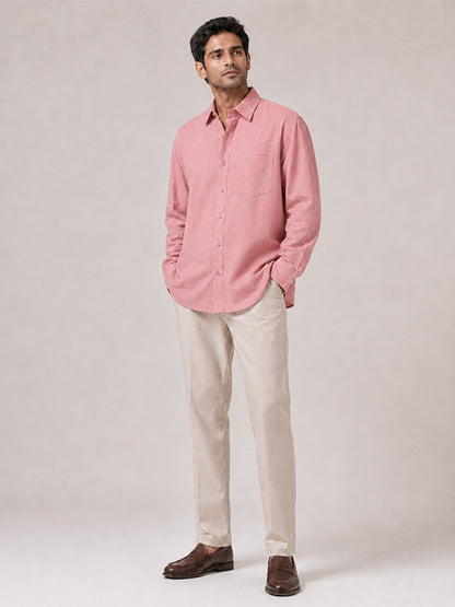 Men's blush pink full-sleeve shirt styled with cream trousers