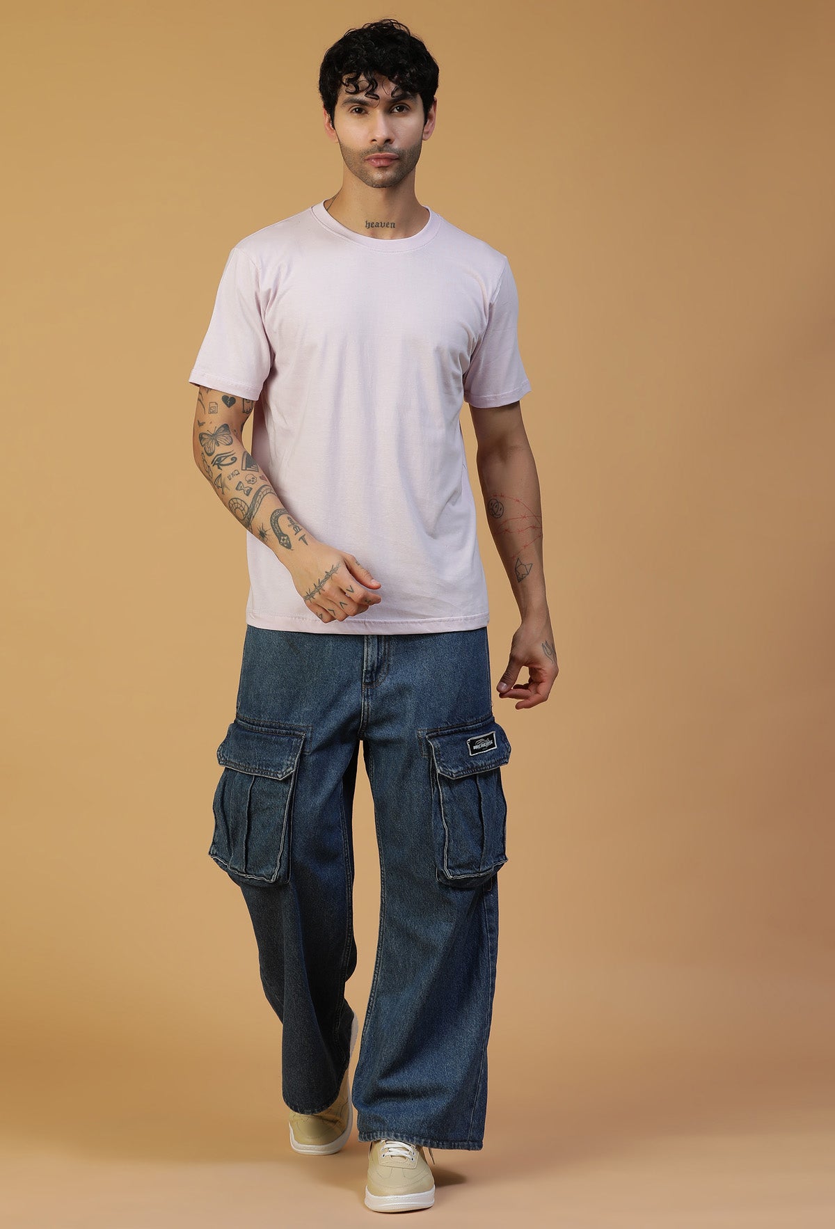 Man wearing a lavender regular-fit cotton T-shirt with blue jeans