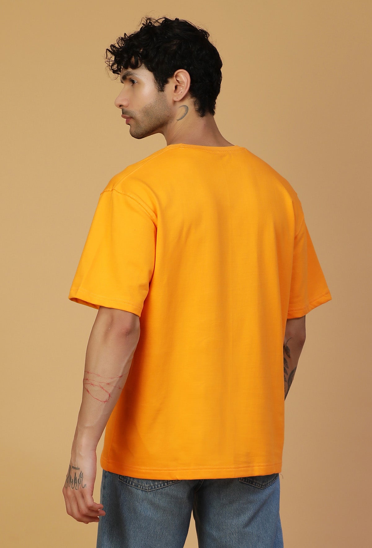 Back view of men's solid mustard oversized T-shirt
