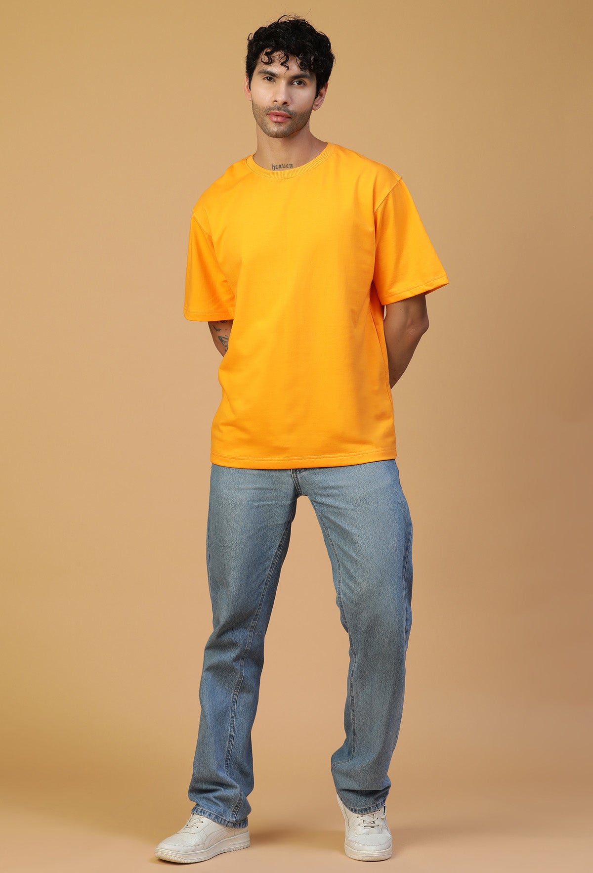 Full-length view of men's mustard oversized cotton T-shirt