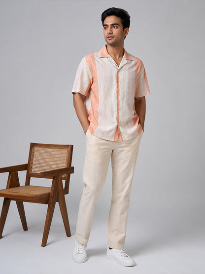 Men's peach striped linen-cotton shirt styled with cream trousers