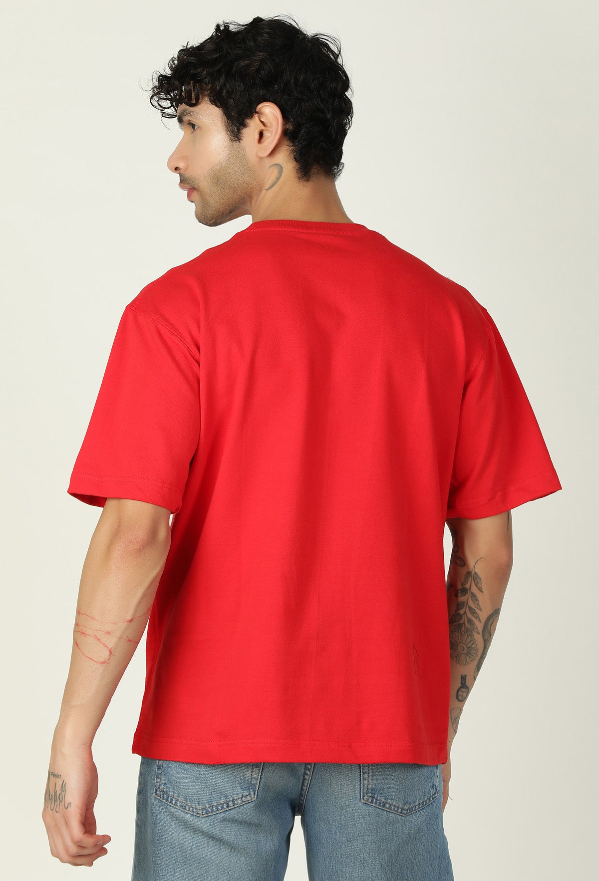 Back view of men's solid red oversized half-sleeve T-shirt