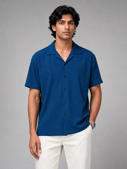 Man wearing a royal blue textured ribbed relaxed-fit half-sleeve shirt