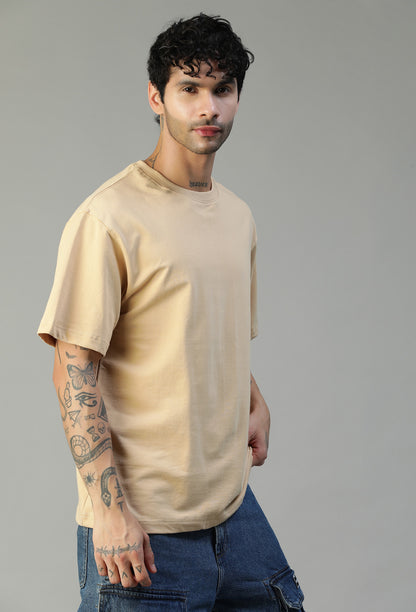 Man wearing a solid beige pure cotton oversized T-shirt