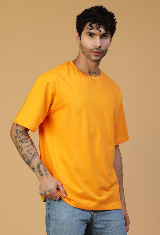 Man wearing a solid mustard pure cotton oversized T-shirt