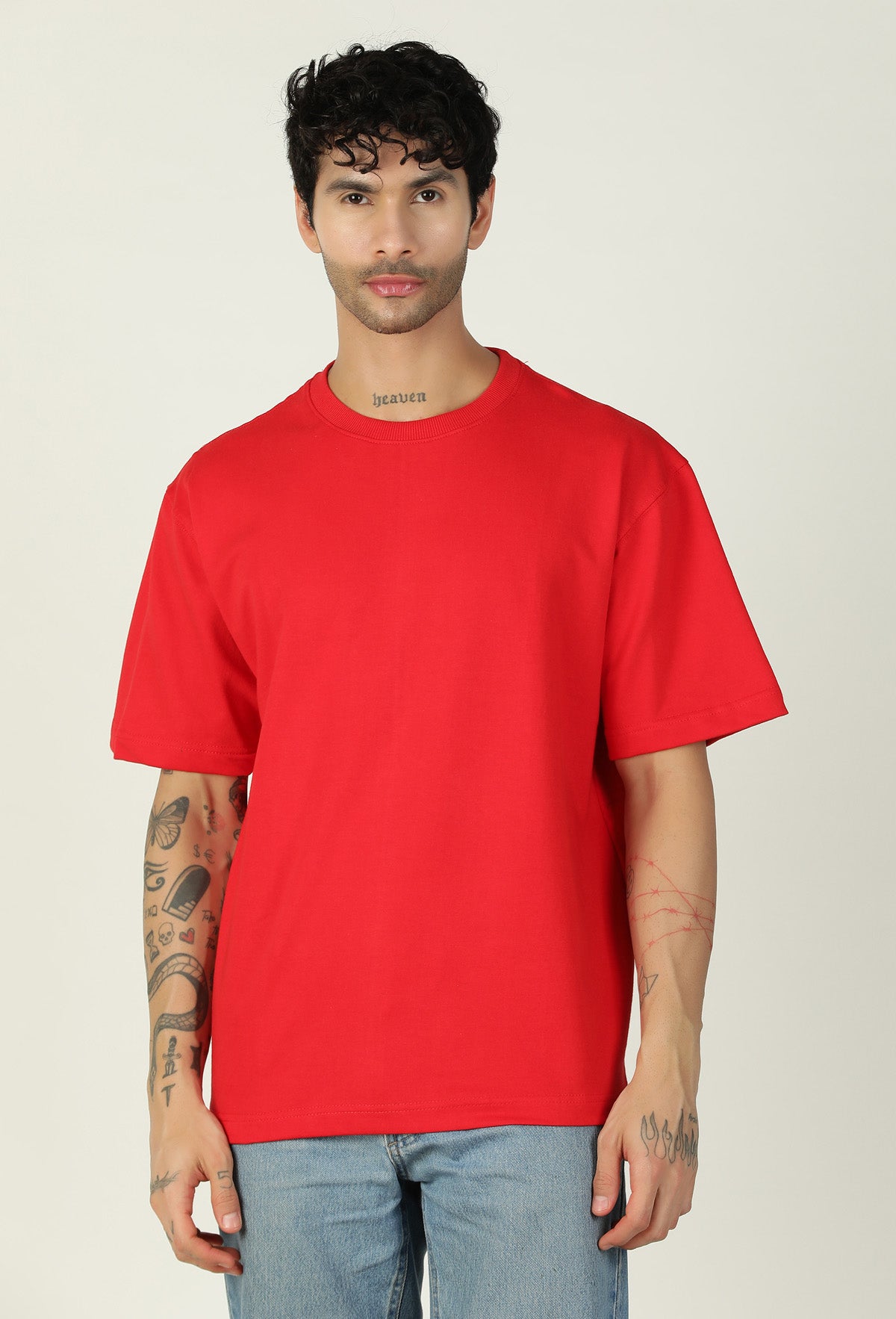 Man wearing a solid red pure cotton oversized T-shirt