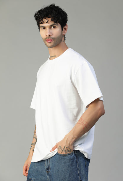 Man wearing a solid white pure cotton oversized T-shirt