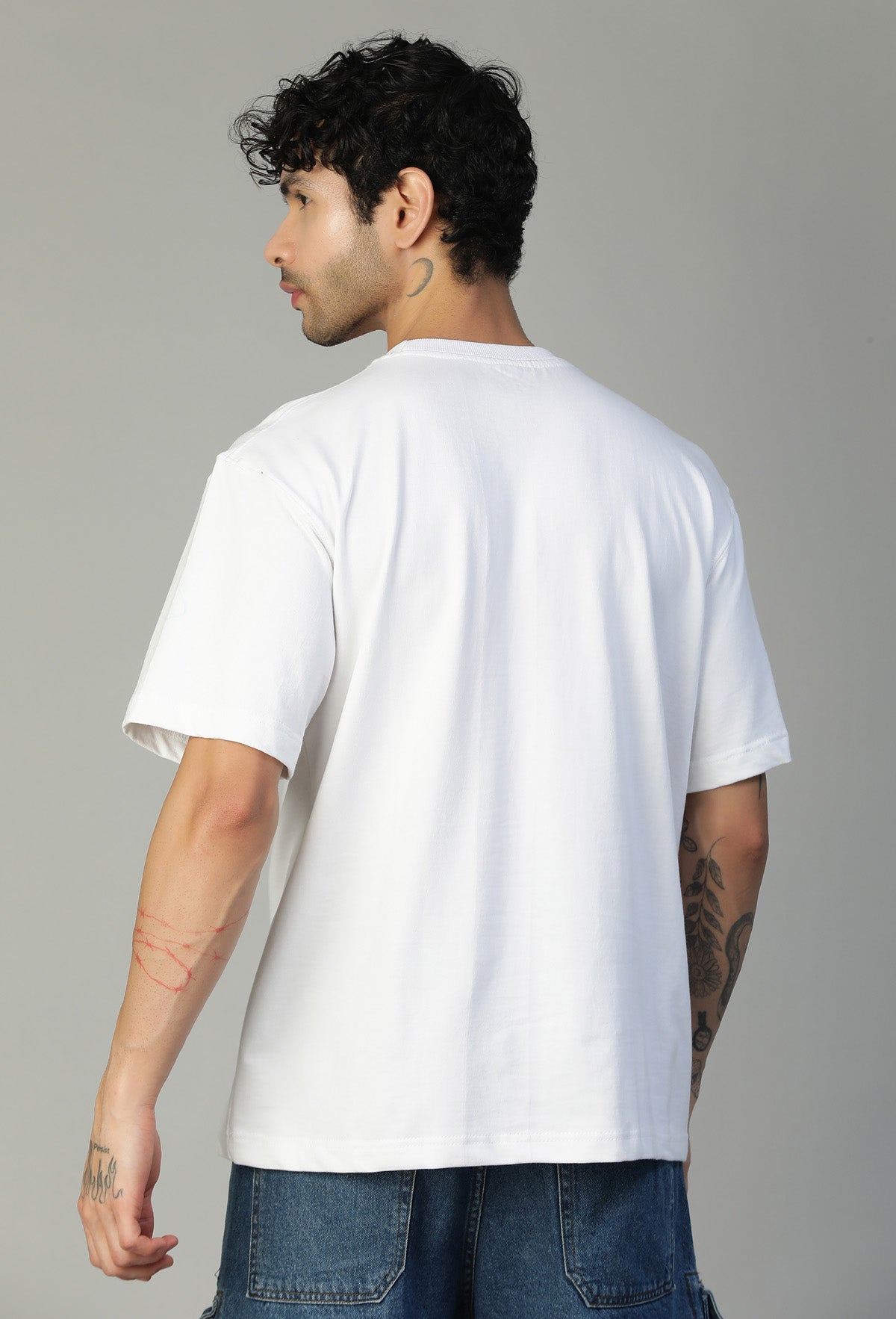 Back view of men's solid white oversized half-sleeve T-shirt