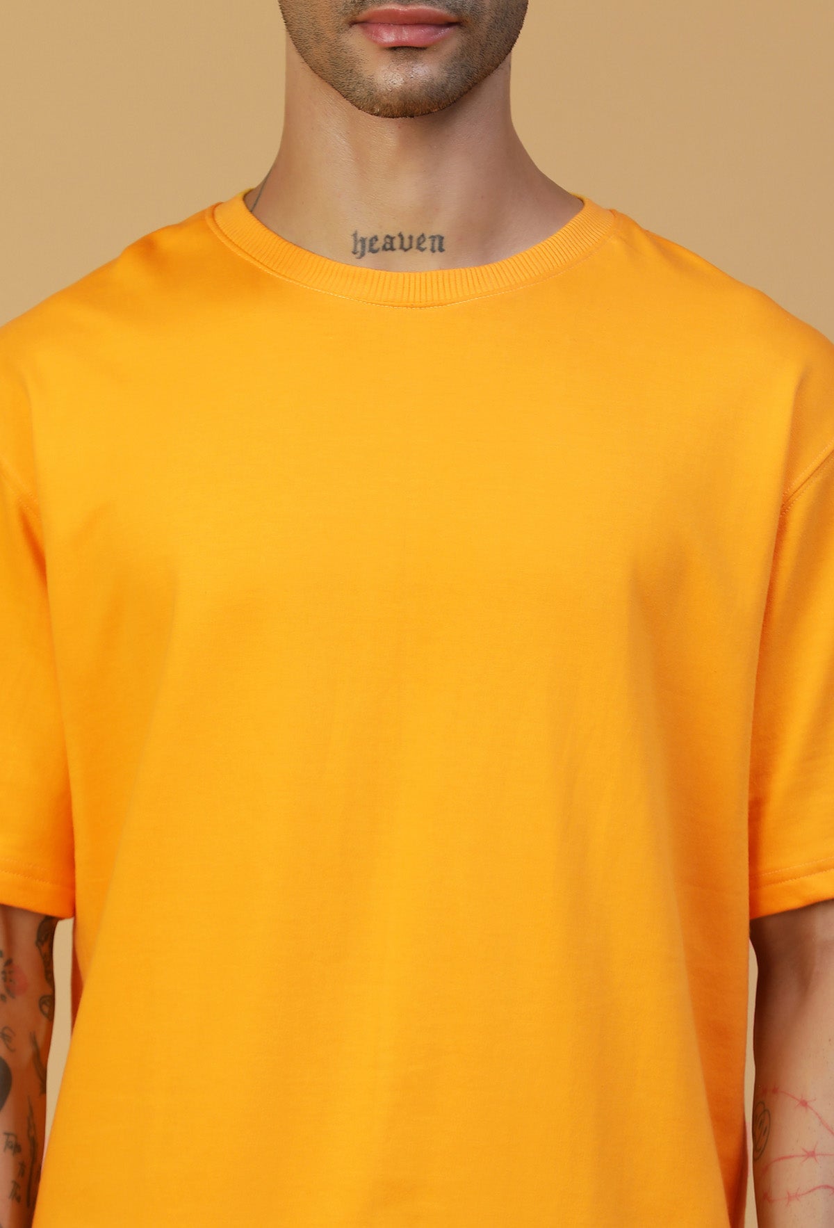 Close-up of mustard cotton oversized T-shirt crew neck and fabric