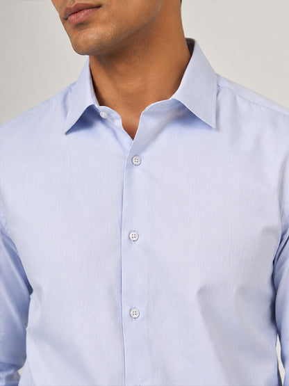 Close-up of sky blue textured cotton shirt collar, buttons and fabric